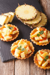 Mini Tart with fresh pineapple and jam closeup. vertical