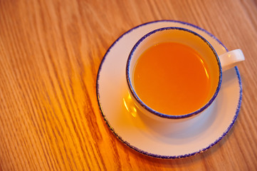 cup of fruit tea on a wooden table