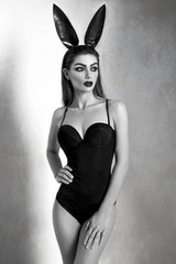 Young woman in black sexy bodysuit, black and white photo