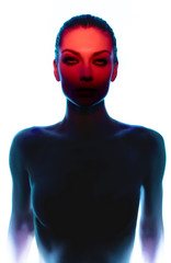 Young woman posing in darkness with red light on white studio background