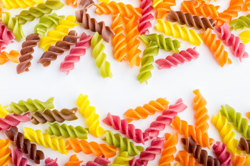Background of colorful pasta texture close-up. Assortment of colorful macaroni. italian pasta. Variety of types and shapes of dry Italian pasta. Full background of dry uncooked macaroni.