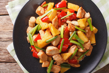 fried chicken with pineapple in sweet and sour sauce close-up. Horizontal top view