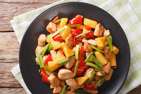 roasted chicken breast with pineapple and vegetables in sweet and sour sauce. Horizontal top view