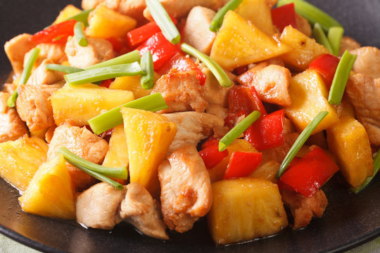 chicken breast with pineapple and vegetables in sweet and sour sauce macro. horizontal
