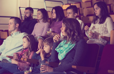 People eating popcorn in cinema