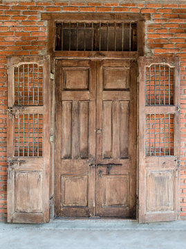 Ancient wooden door on the brick wall