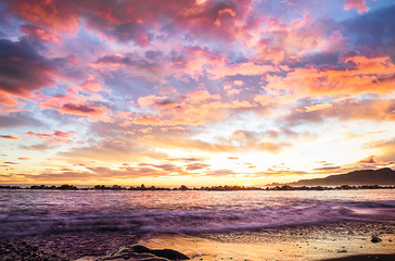 Fototapeta na wymiar romantic clouds over beach at sunset
