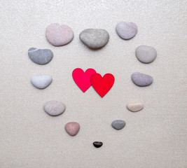 Two red hearts lie on the stone background