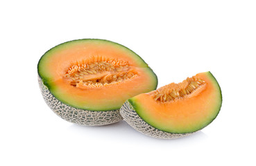half and portion cut ripe cantaloupe on a white background