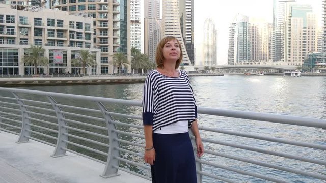  beautiful woman walking on the waterfront in Dubai 