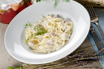 tagliatelle carbonara with bacon, cream sauce and cheese Parmigi