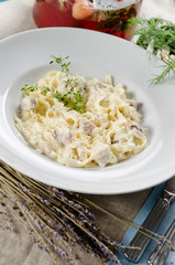 tagliatelle carbonara with bacon, cream sauce and cheese Parmigi