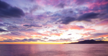 Obraz premium cloud,purple sunset on the sea with Portofino mount in the back