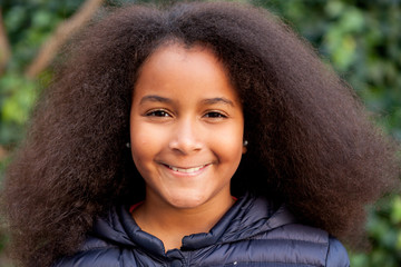 Pretty girl with long afro hair with a blue coat