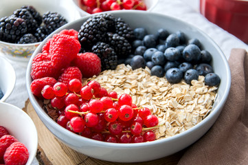 Big bowl of oat granola with berries. Breakfast concept.