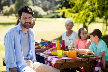 Portrait of smiling man sitting in park