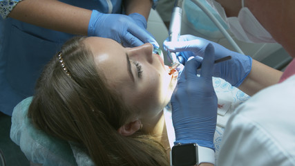 Patient for preventive medical checkup at dentist with probe and mirror
