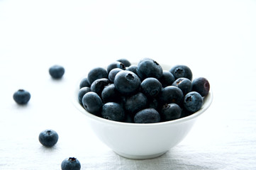 Blackberries in a white little bowl on a white background