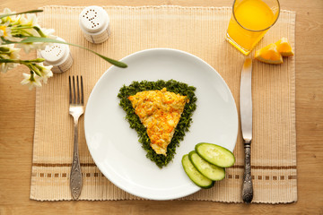 Healthy vegetarian breakfast with omelet made with vegetables and eggs, fresh orange juice. Fast cooking lunch with organic ingredients.