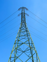 Metal pole high voltage against the blue sky.