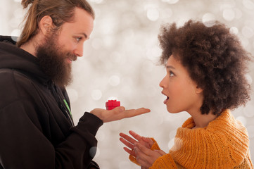 Smiling couple with engagement ring in gift box