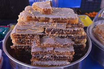 honey in honeycomb on the tray on the stall in bazaar turkey
