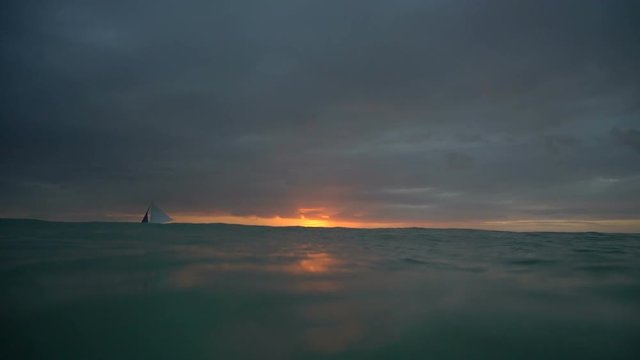 Marine beautiful nature background. Sail boats on horizon at sunset in Boracay tropical island underwater camera