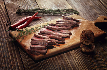 Fototapeta na wymiar Roast beef steak on a wooden stand.
