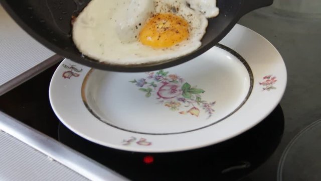 Eggs sunny side shifted from the pan onto a plate