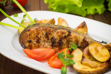 Deep Fried Dolly Fish Steak with French fries on wood background. Top view. Close-up