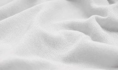 Fotobehang Stof De textuur van een gebreide wollen stof wit.