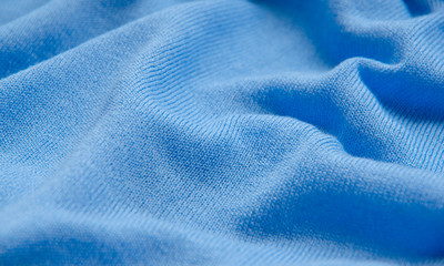 The texture of a knitted woolen fabric blue.