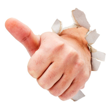 Thumbs up hand sign breaking through thorn paper isolated on white.