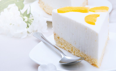 cheesecake with peaches on white plate