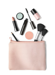 Aerial view of make up products spilling out of a pastel pink cosmetics bag, isolated on a white background