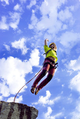 Jump rope from a high rock in the mountains.