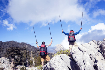 Summer hiking in the mountains with a backpack .