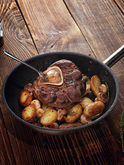 Fried ossobuco with vegetable ragout of potatoes and mushrooms.