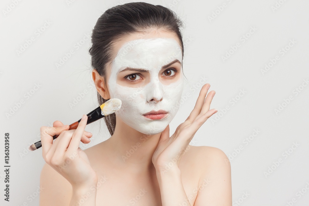 Wall mural cream on make-up brush and white face mask