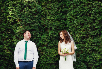 The couple in love stands near trees