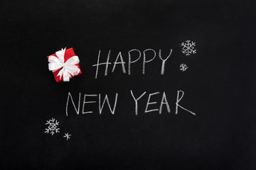 Fototapeta na wymiar HAPPY NEW YEAR text , handwriting, on blackboard