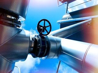 Industrial zone, Steel pipelines and valves against blue sky
