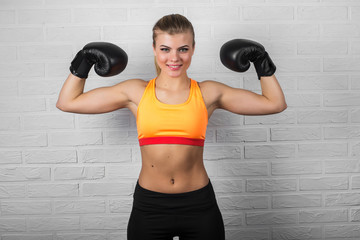 Young adult sexy boxing girl posing with gloves.