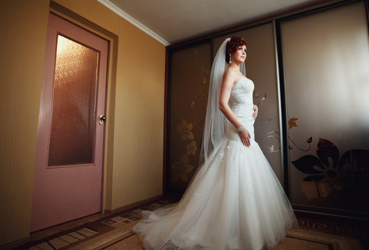 creative bride posing for the camera in her room