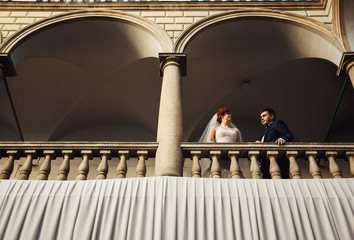 Naklejka na ściany i meble happy woman and her husband enjoys the view from the balcony