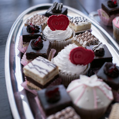 Dessert table for a party. Ombre cake, cupcakes, sweetness and flowers
