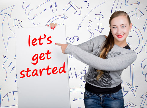 Young Woman Holding Whiteboard With Writing Word: Let's Get Started. Technology, Internet, Business And Marketing.