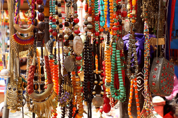 Artificial stones, pearls, beads rosary, bangles, purse hanging in a street shop