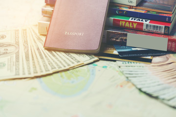 Traveling concept :  Passport , books , map , U.S. dollar bills and Thai banknotes