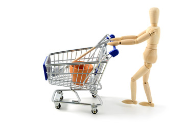 wooden mannequin shopping with a cart on white isolated backgrou